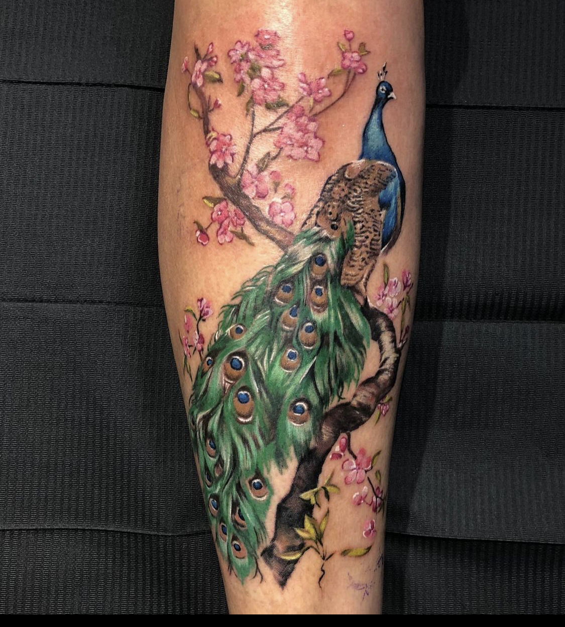 Creatures from the orient, including a peacock, feature in this geometric  and colorful tattoo by Amanda Chamfreau | Ratta Tattoo