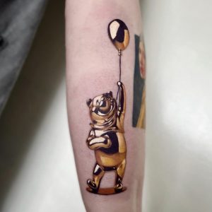 metallic tattoo of Winnie the Pooh